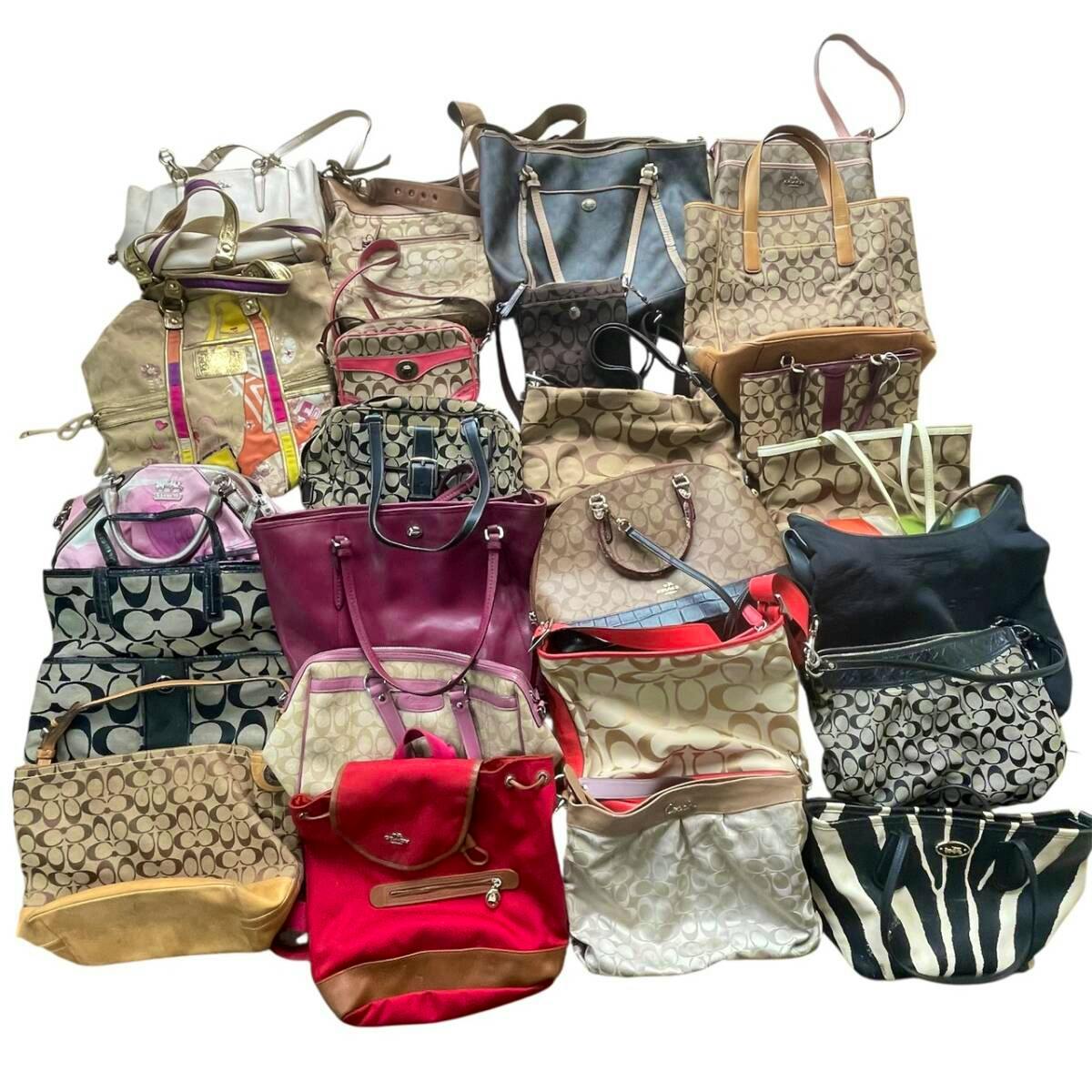 Multiple Coach tote and shoulder bags in various patterns and colors arranged in rows against a white background.