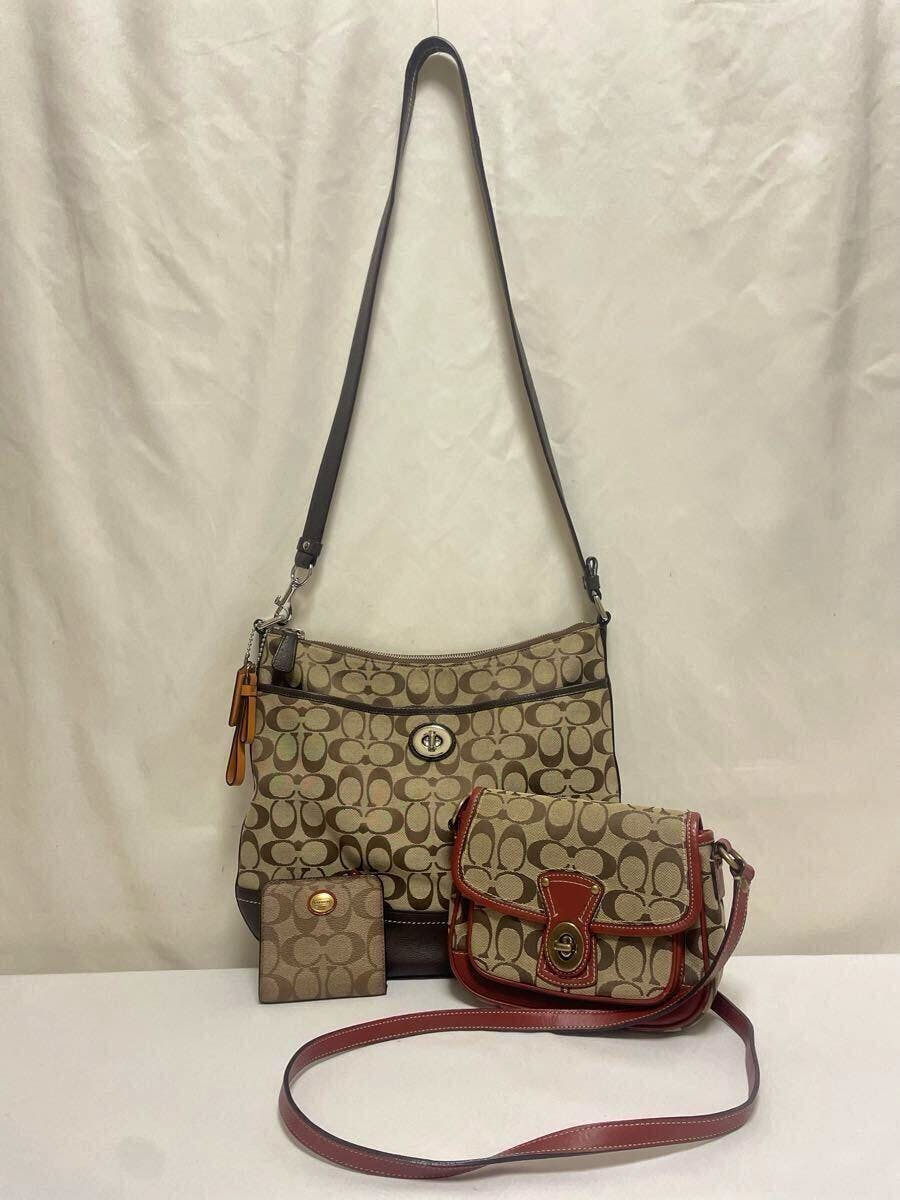 Three Coach pieces (two shoulder/crossbody bags and one wallet) in brown and red tones arranged against a plain light backdrop.