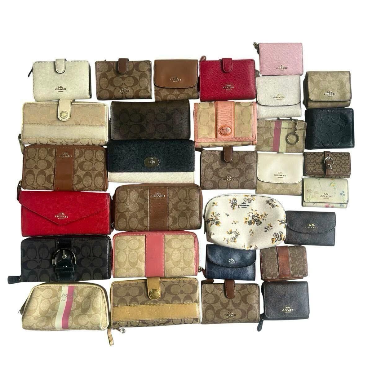 Flat lay photo showing multiple COACH wallets, coin cases, and pouches arranged together on a white background.
