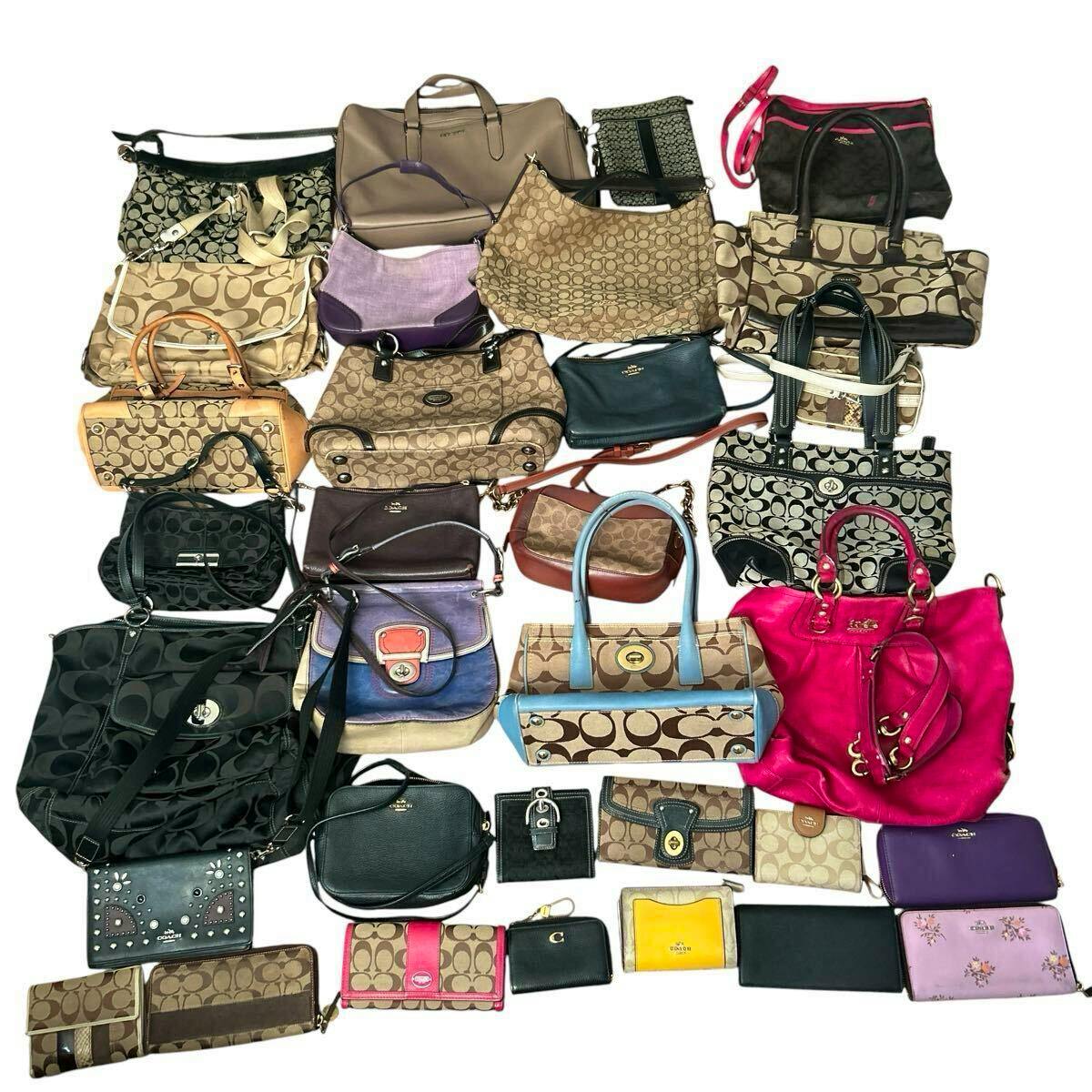 A large assortment of COACH bags, purses, and wallets arranged on a white background.