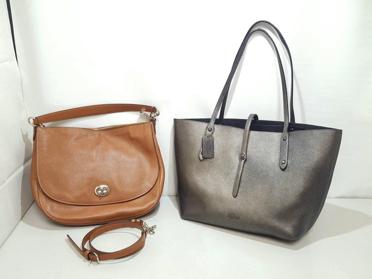 Two COACH bags on a white background: a brown leather 2-way shoulder bag with a detachable strap and a metallic tote with long handles.