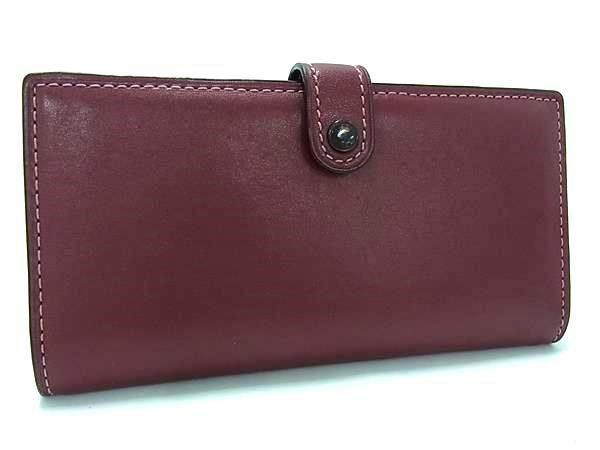 Burgundy leather tri-fold long wallet with a snap-tab closure shown from the front.
