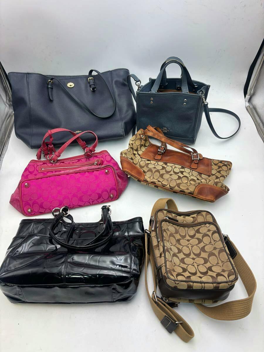 Six COACH bags in various styles and colors arranged on a white background.