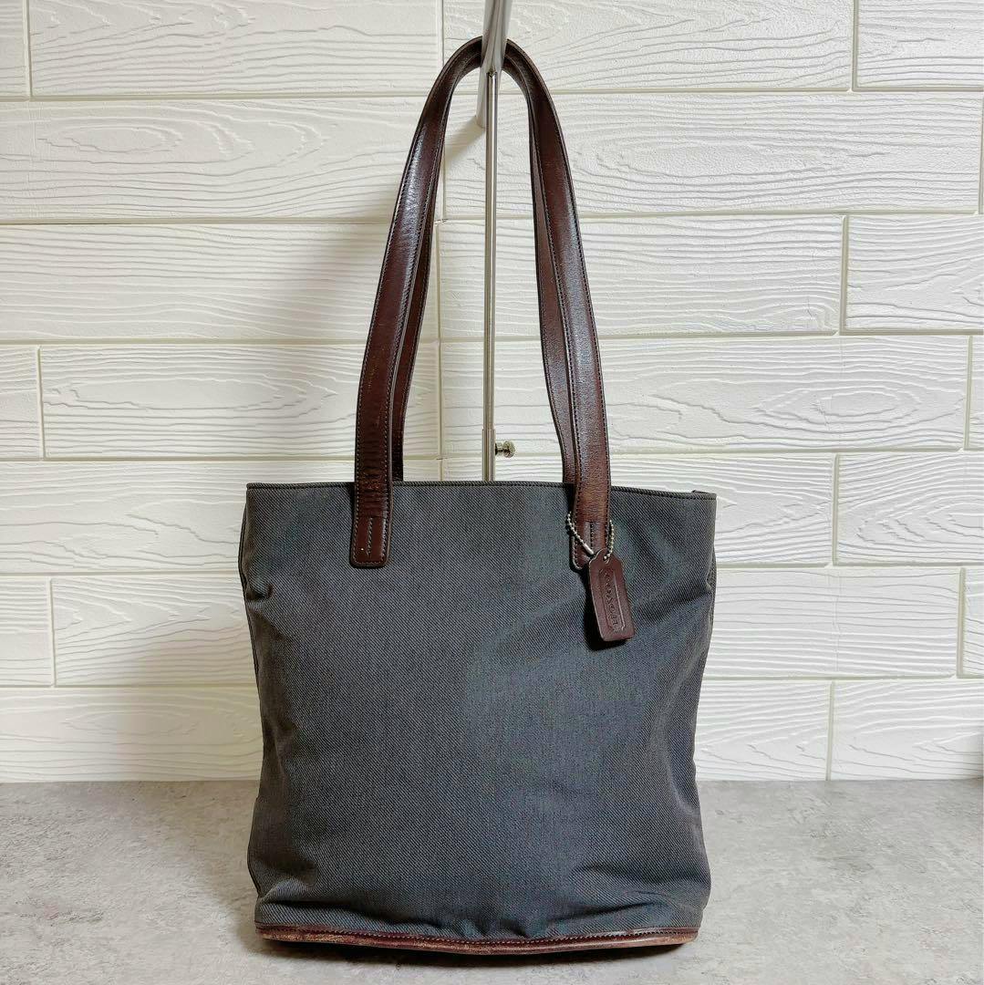 Front view of the COACH No.415 leather-handled tote bag hanging on a stand.