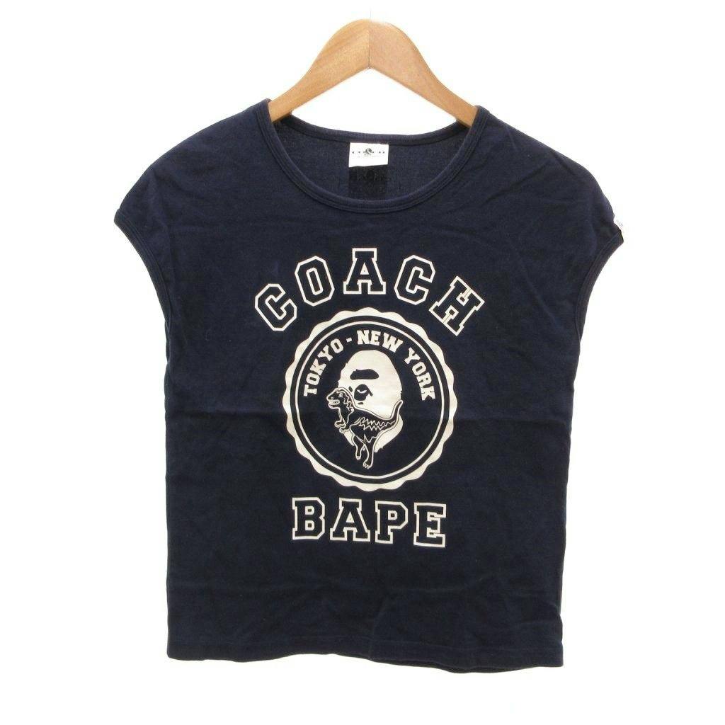 Front view of a navy sleeveless cotton T-shirt on a hanger with Coach × BAPE logo print.