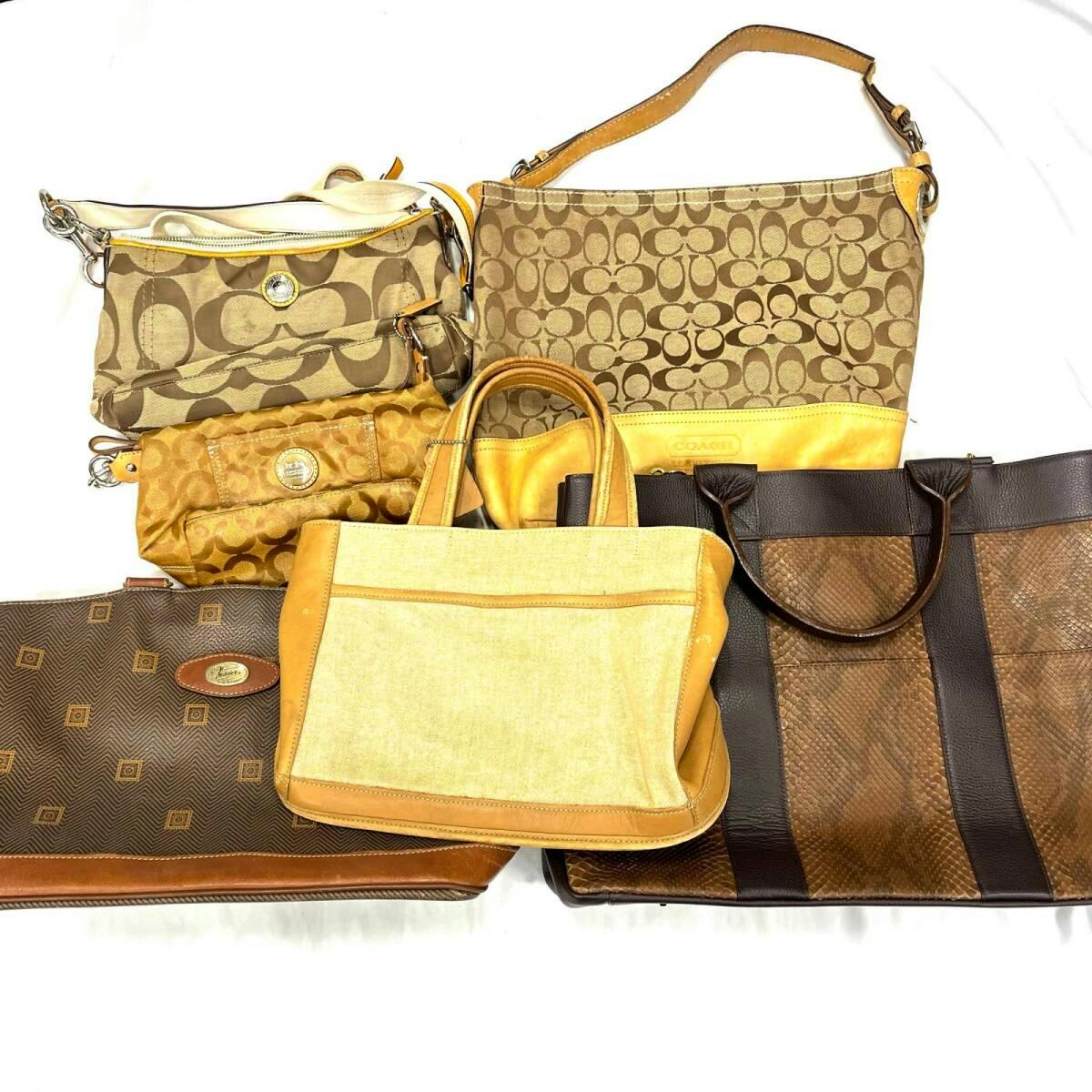 Several handbags, including Coach canvas and leather bags, arranged on a white background.