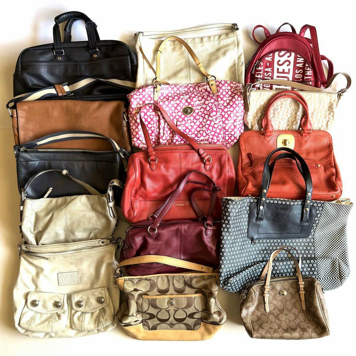Assortment of COACH bags arranged on a light background, showing multiple handbags and shoulder bags from the set.