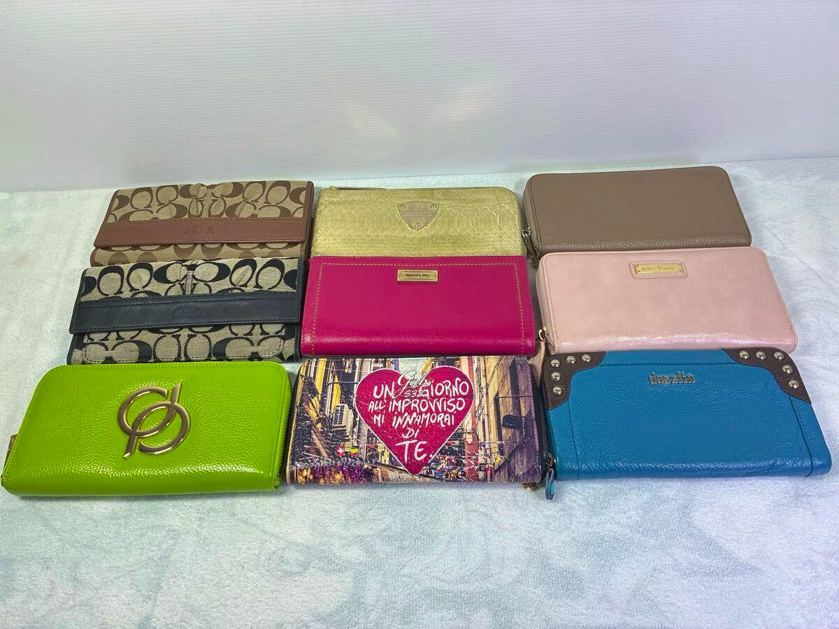 Nine women's long wallets in various colors and patterns arranged in three rows on a light surface.