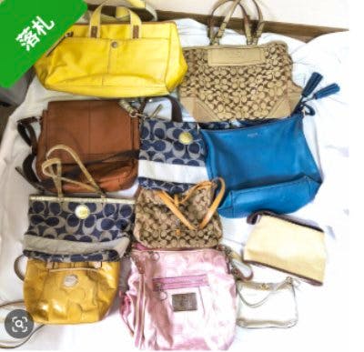 Eleven COACH bags and purses in various colors and styles arranged on a flat surface.