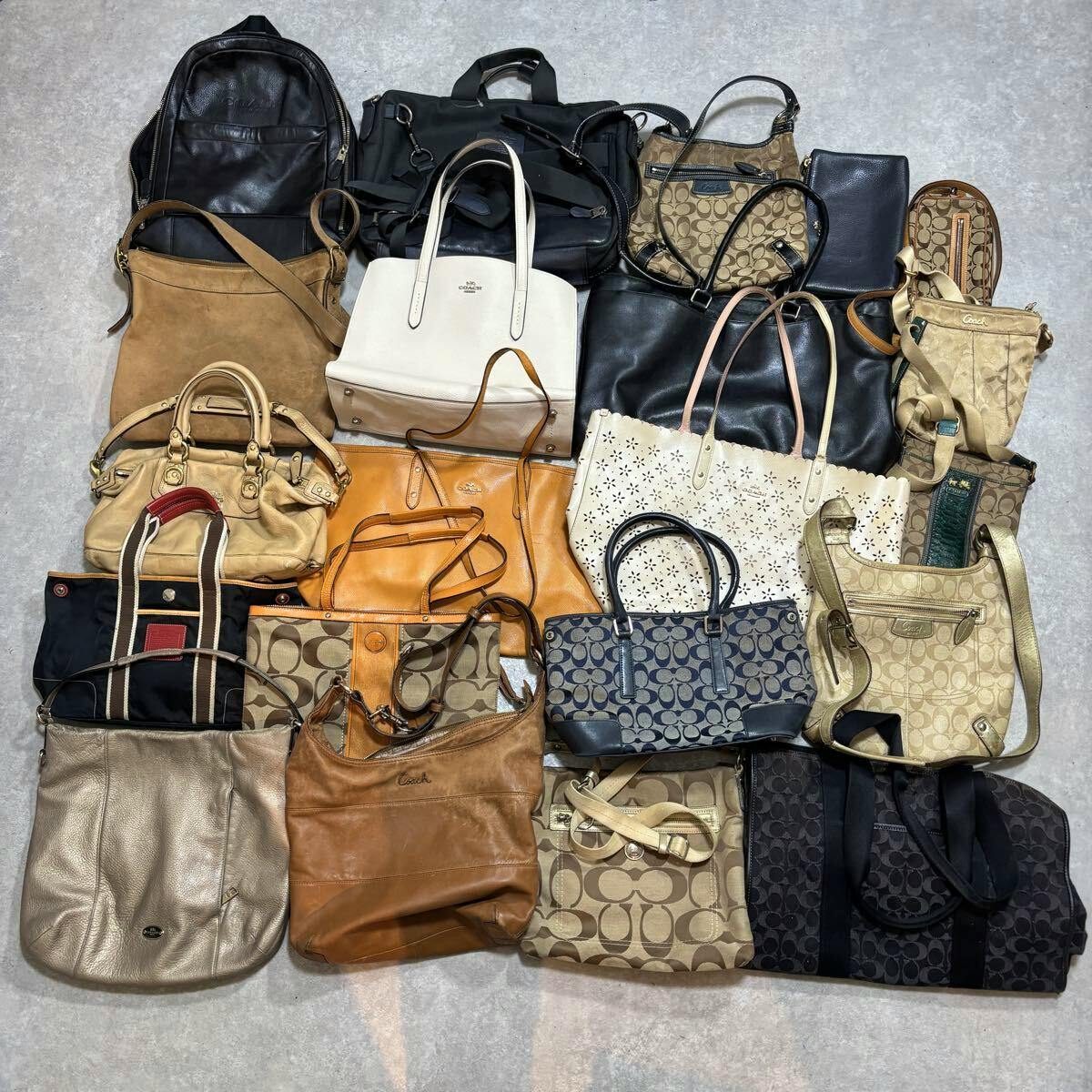 Overhead photo of a bulk set of Coach bags (as listed), showing multiple satchel, tote, and shoulder styles arranged on the floor.