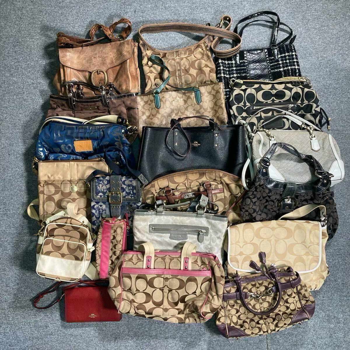 Overhead photo of a set of Coach bags and pouches laid out on a gray floor, showing many signature canvas and leather styles.