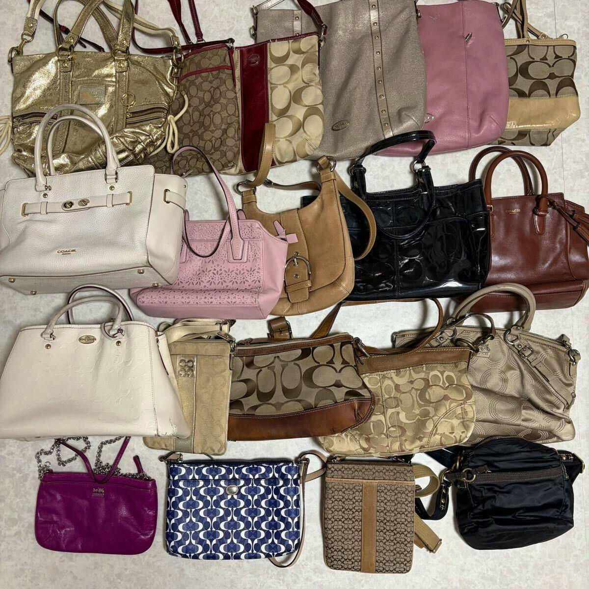 Multiple Coach canvas and leather bags arranged in a flat lay showing various shoulder, tote, and crossbody styles.
