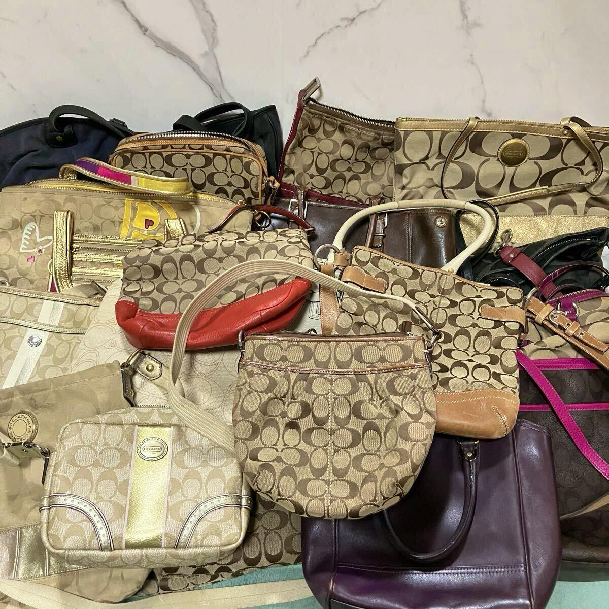 Several COACH bags with the signature 'C' canvas pattern and various straps arranged together on a surface.