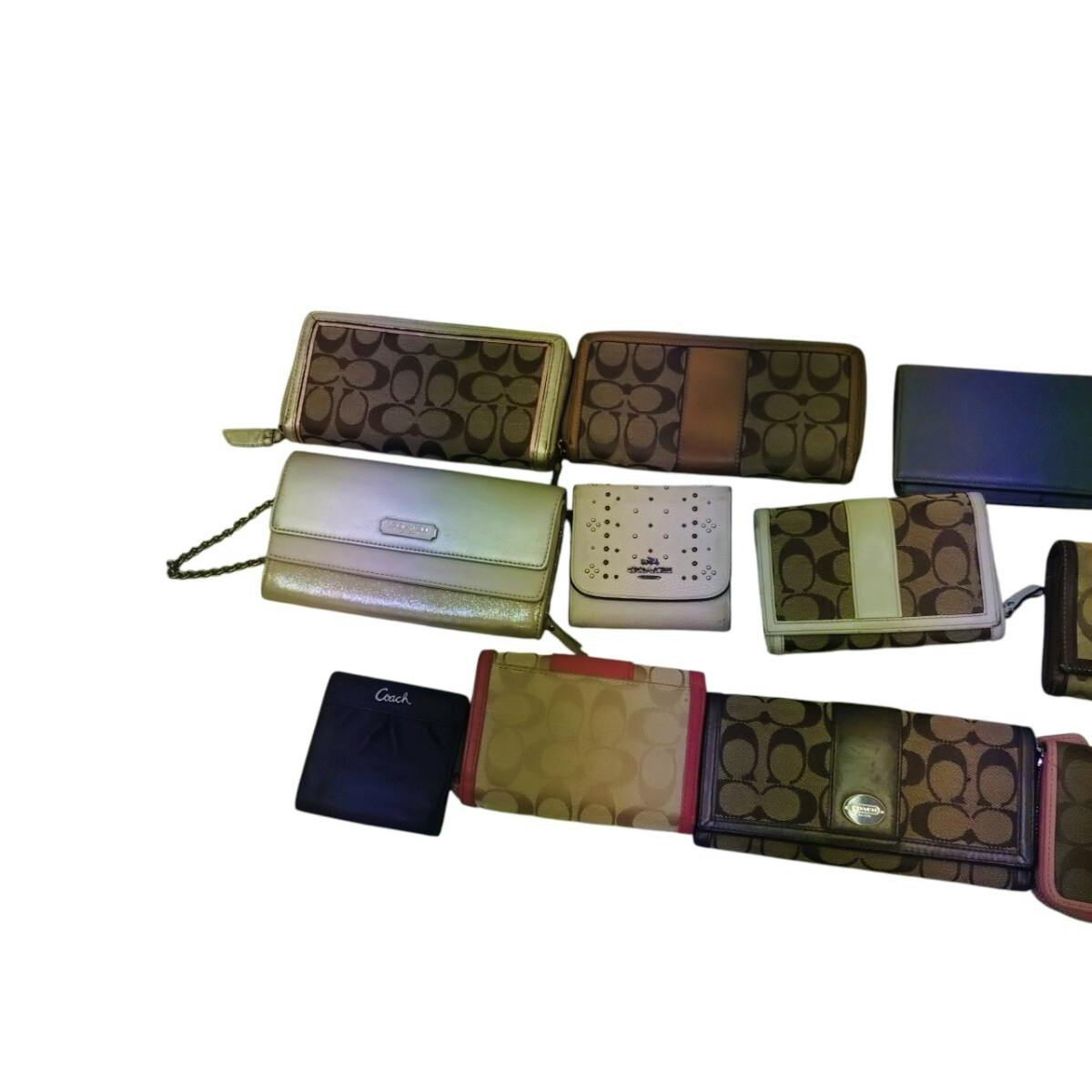 Multiple Coach wallets and small leather goods laid out on a white background.