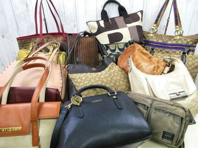 Multiple designer bags from the set arranged together showing various styles and materials (leather, PVC, nylon, canvas).