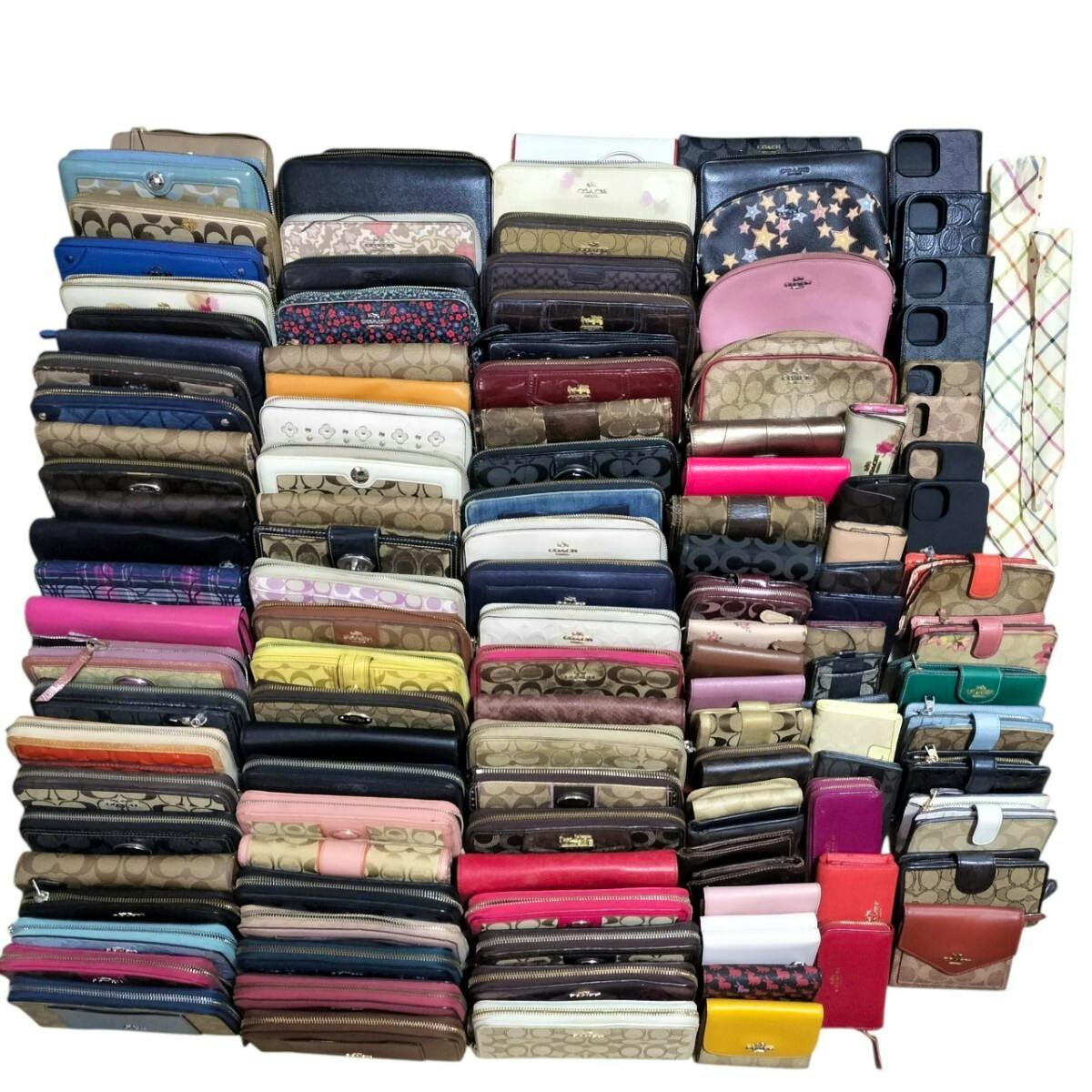 Bulk set of Coach wallets and small wallets arranged in rows showing many long wallets and coin purses.