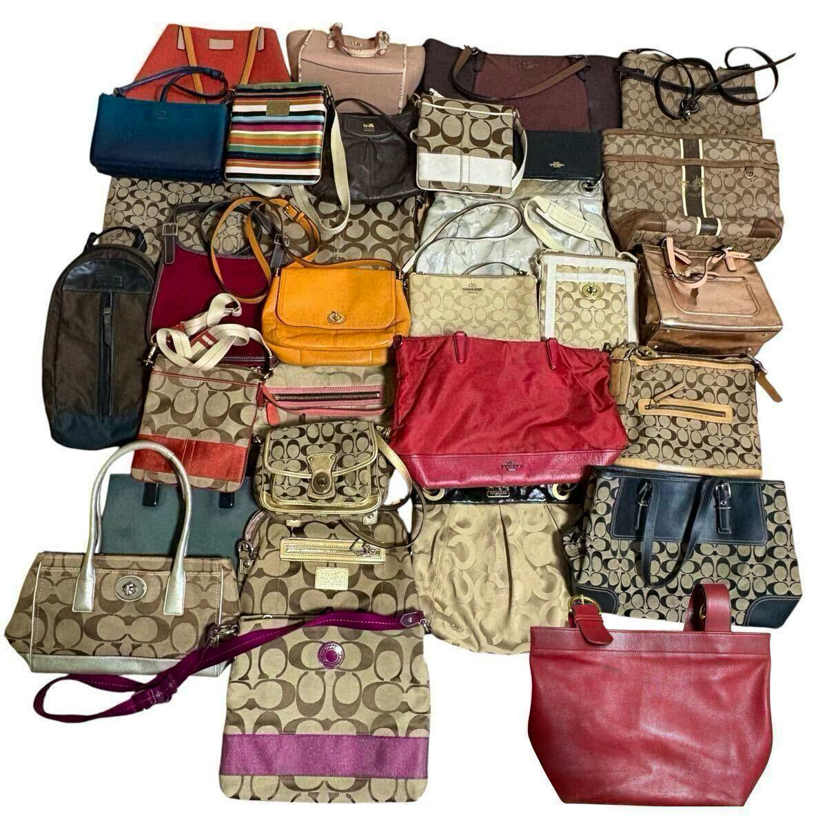 A flat lay of many COACH bags and totes arranged together, showing assorted colors, styles, and signature 'C' monogram patterns.