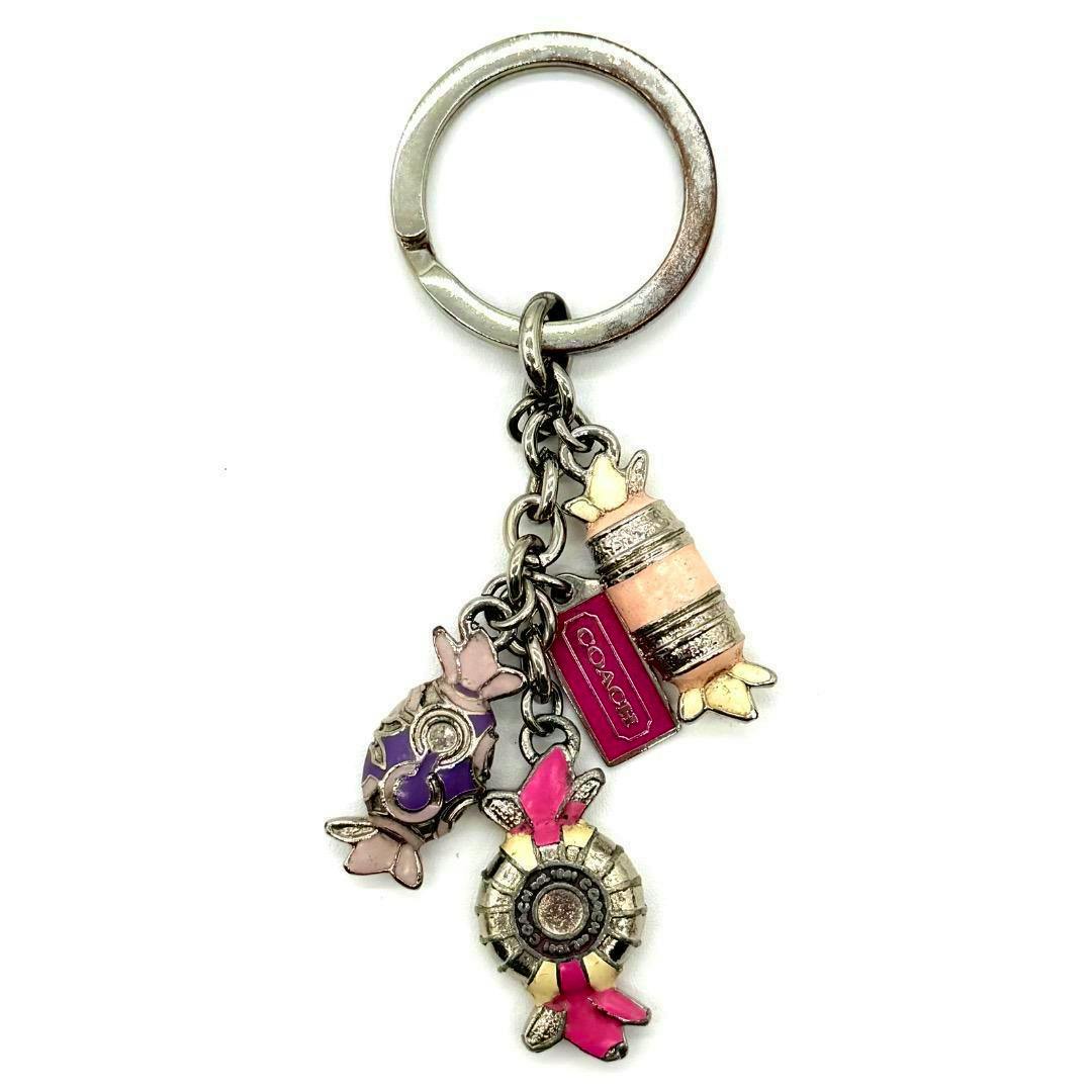 COACH candy bag charm key ring with a silver-tone ring and three colorful candy-shaped enamel charms plus a small rectangular Coach tag.