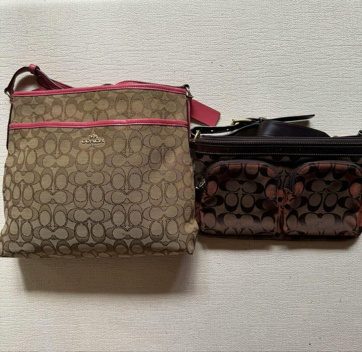 Two COACH canvas bags with the signature C pattern, one with pink trim and a smaller brown pouch-style bag, shown side by side against a textured wall.