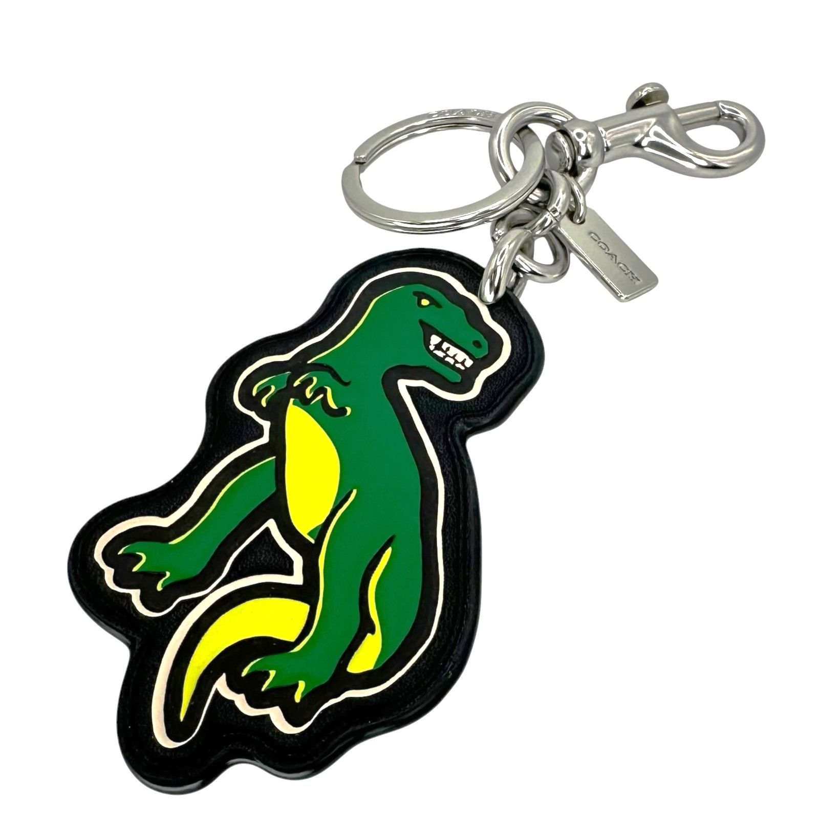 Green dinosaur leather keychain/bag charm with metal ring, lobster clasp, and COACH tag.