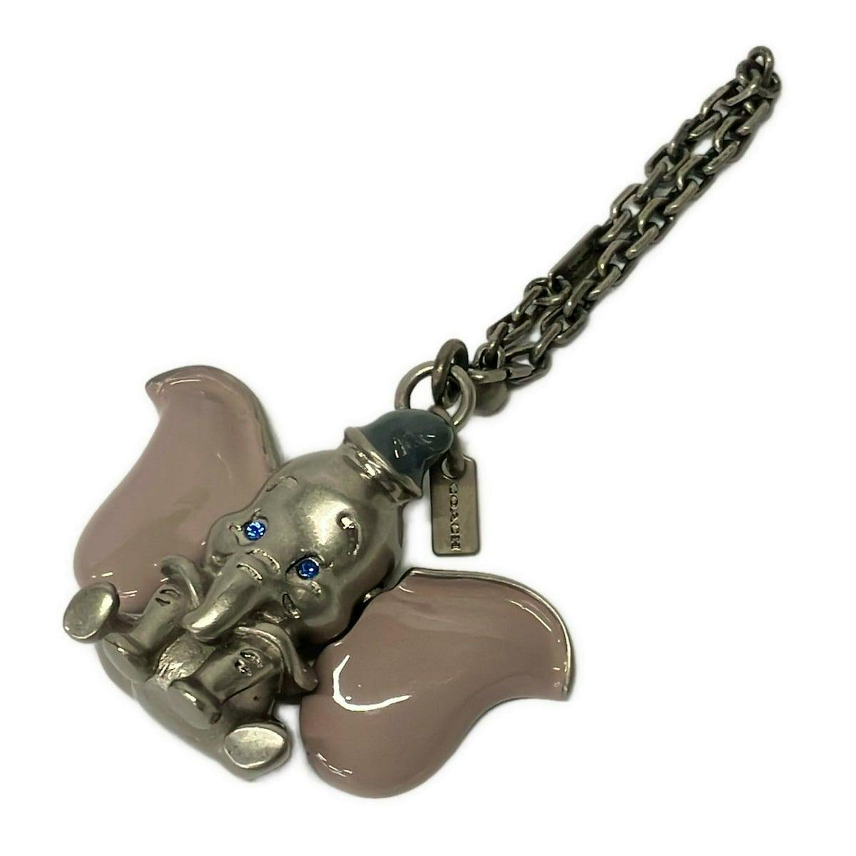 COACH Dumbo bag charm in silver metal with light purple enamel ears, blue rhinestone eyes, and attached chain.