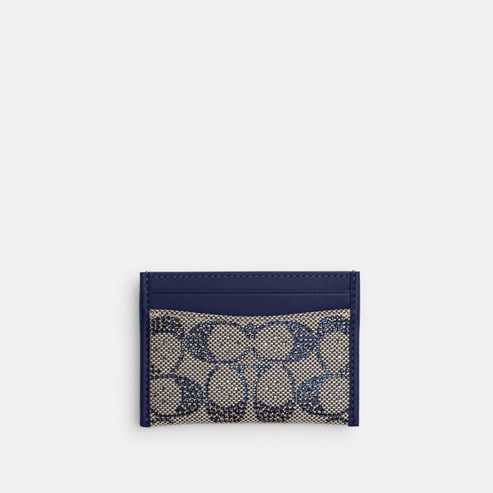Front view of a card case in crystal signature jacquard fabric with navy cow leather trim.