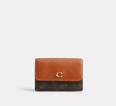 Front view of a mini trifold cow leather wallet with horse-and-carriage print and a gold C emblem.