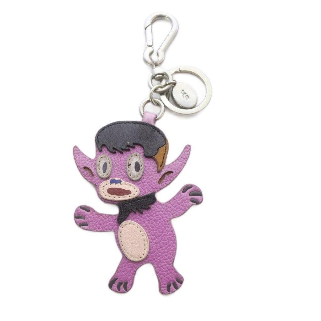 Purple leather Coach × Gary Baseman character keychain with metal ring and clasp.