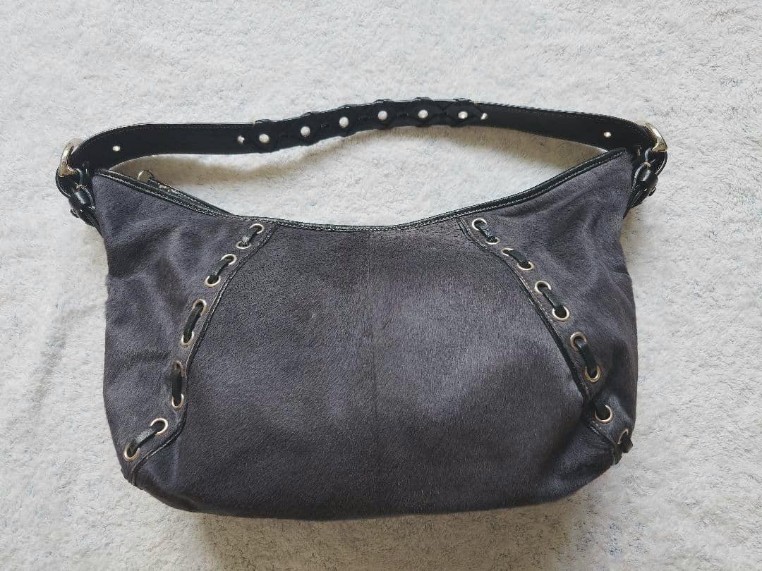 Gray-black COACH one-shoulder bag in haircalf (cow leather) material shown flat on a light surface.