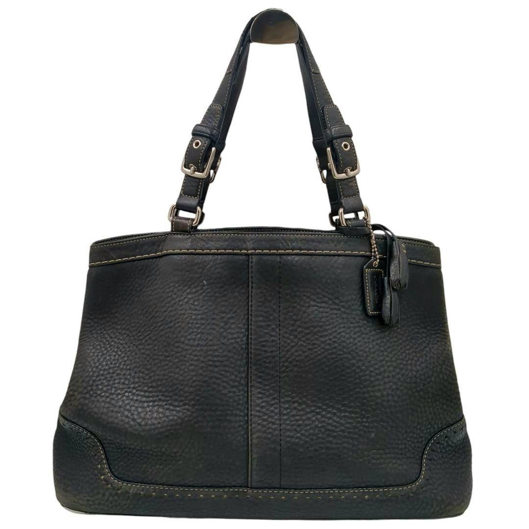 Front view of a black Coach Hampton leather handbag with two shoulder straps and a leather tassel charm.