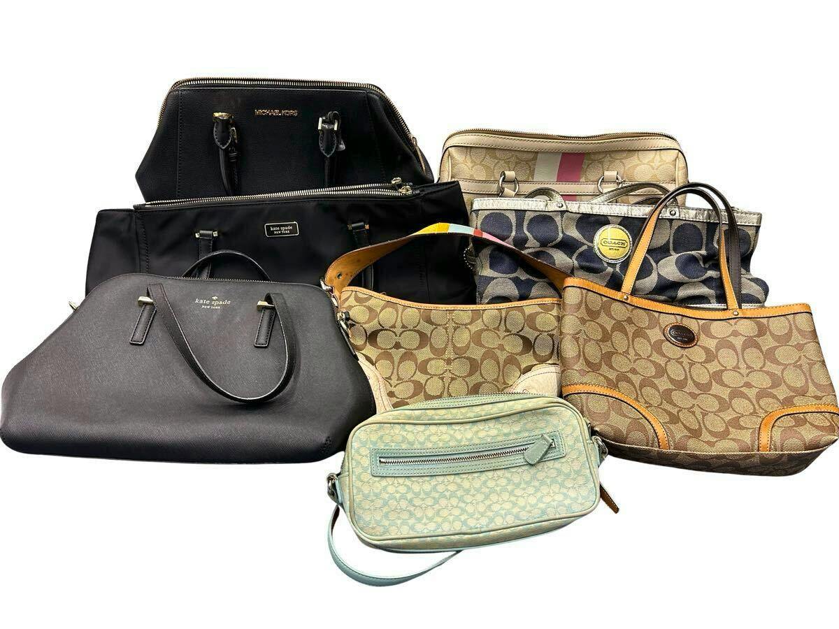 Eight assorted branded handbags (Coach, Kate Spade, Michael Kors) arranged together on a white background.