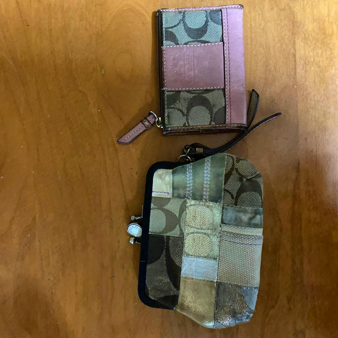 Two Coach items on a wooden surface: a small card case and a patchwork canvas clasp coin purse.
