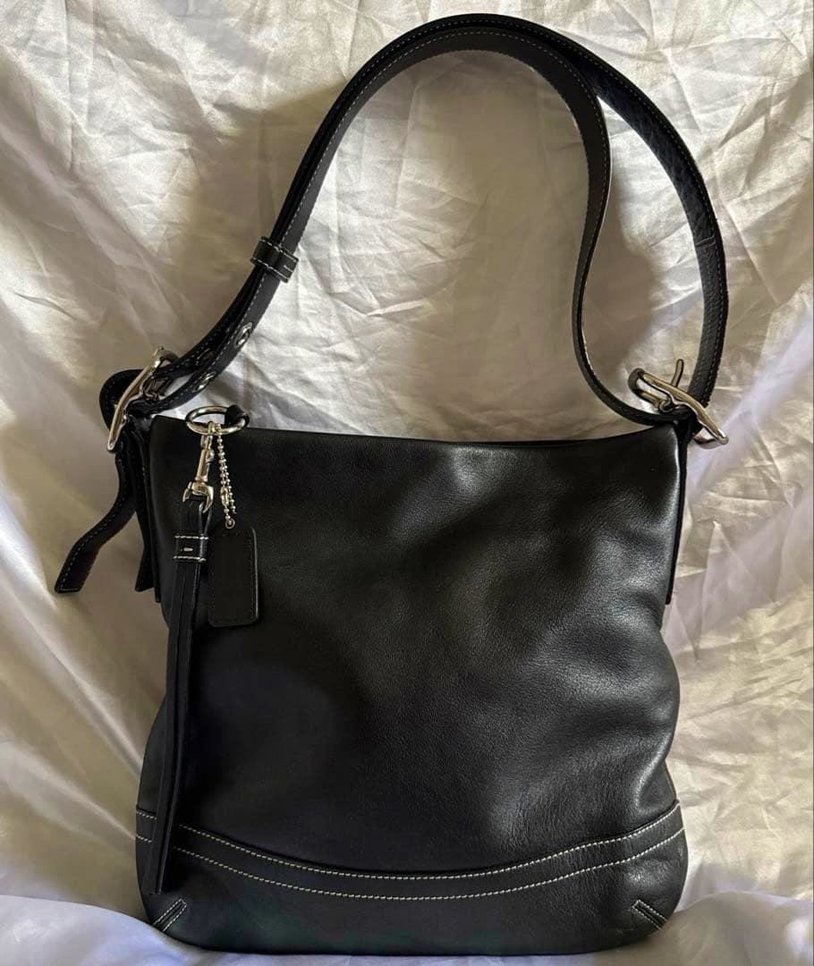 Black COACH leather 2-way shoulder bag shown front view with shoulder strap.