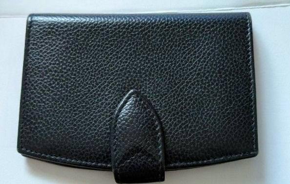 Front view of a black leather card case on a plain white background.
