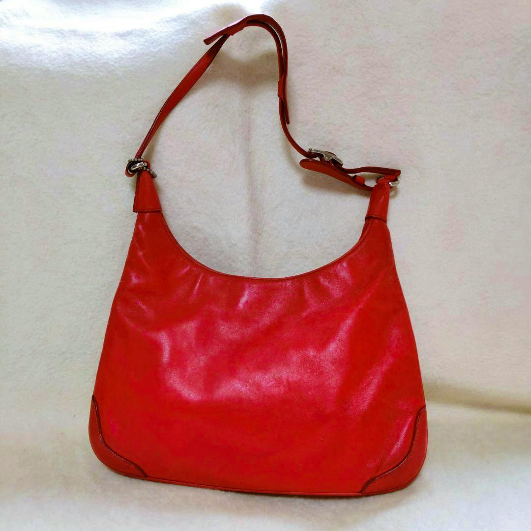 Red Coach hobo leather handbag photographed against a light background.