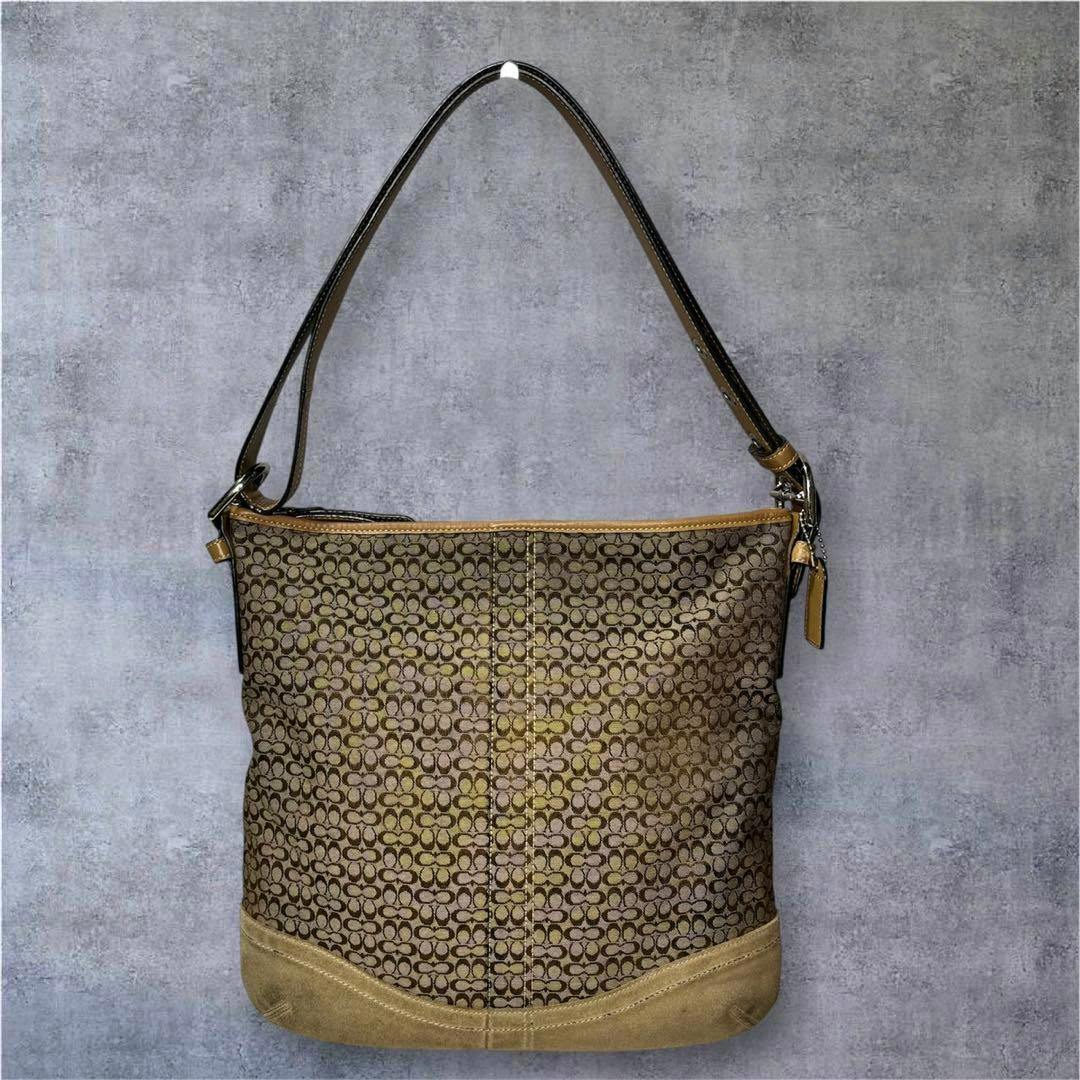 Front view of a Coach signature canvas shoulder bag with leather trim and a single shoulder strap.