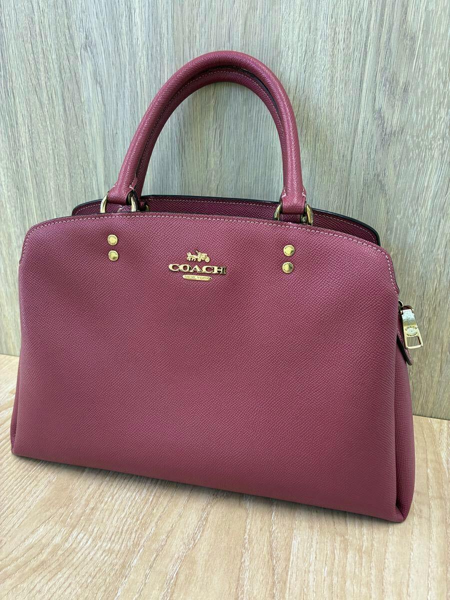 Front view of the COACH rose-pink Lily Carryall 2way handbag in textured synthetic leather with gold hardware and top handles.