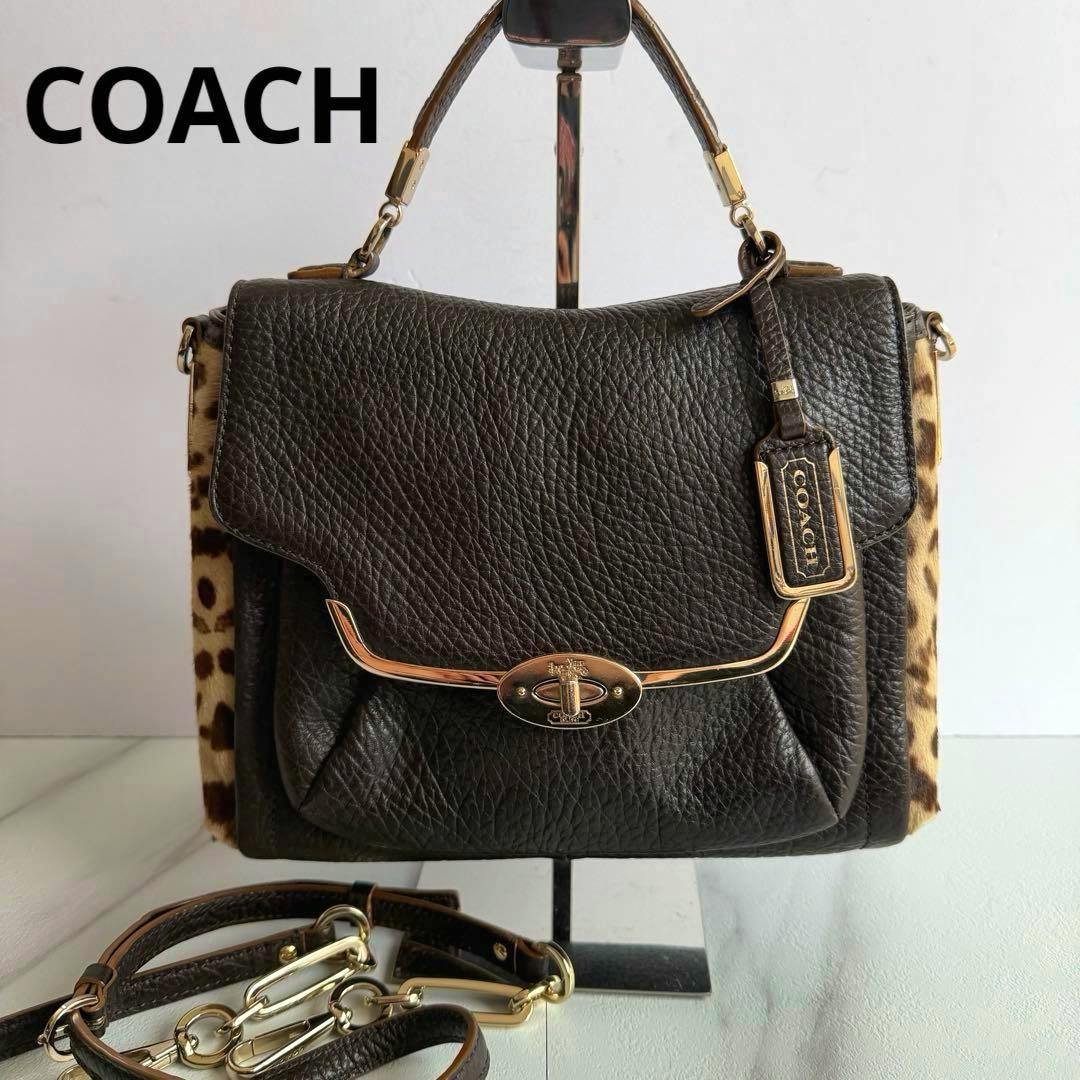 Front view of a dark brown pebbled Coach Madison mixed haircalf bag with gold hardware and the detachable strap visible.