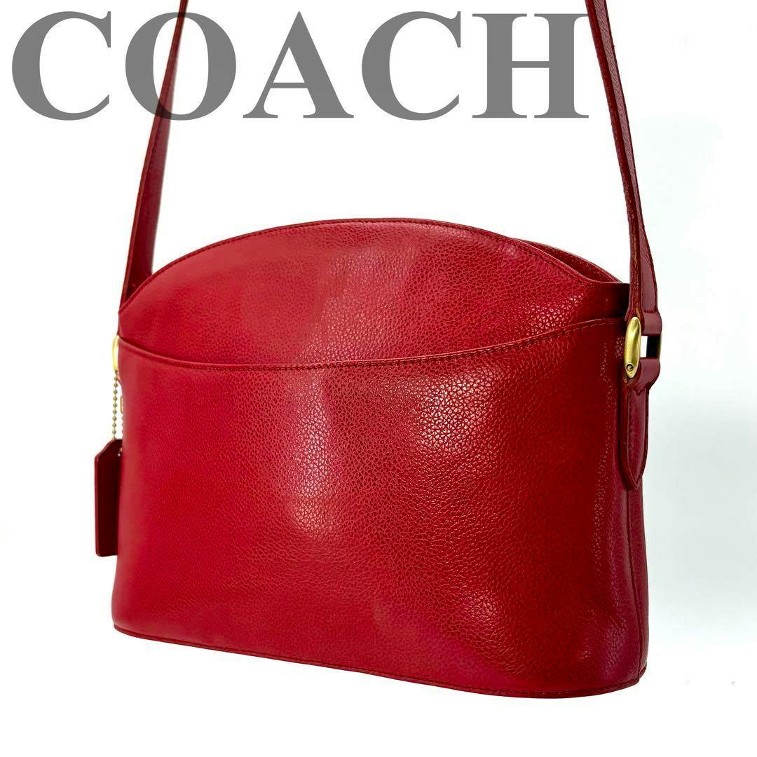 Red COACH Madison shoulder bag shown from the side, displaying pebbled leather texture and shoulder strap.