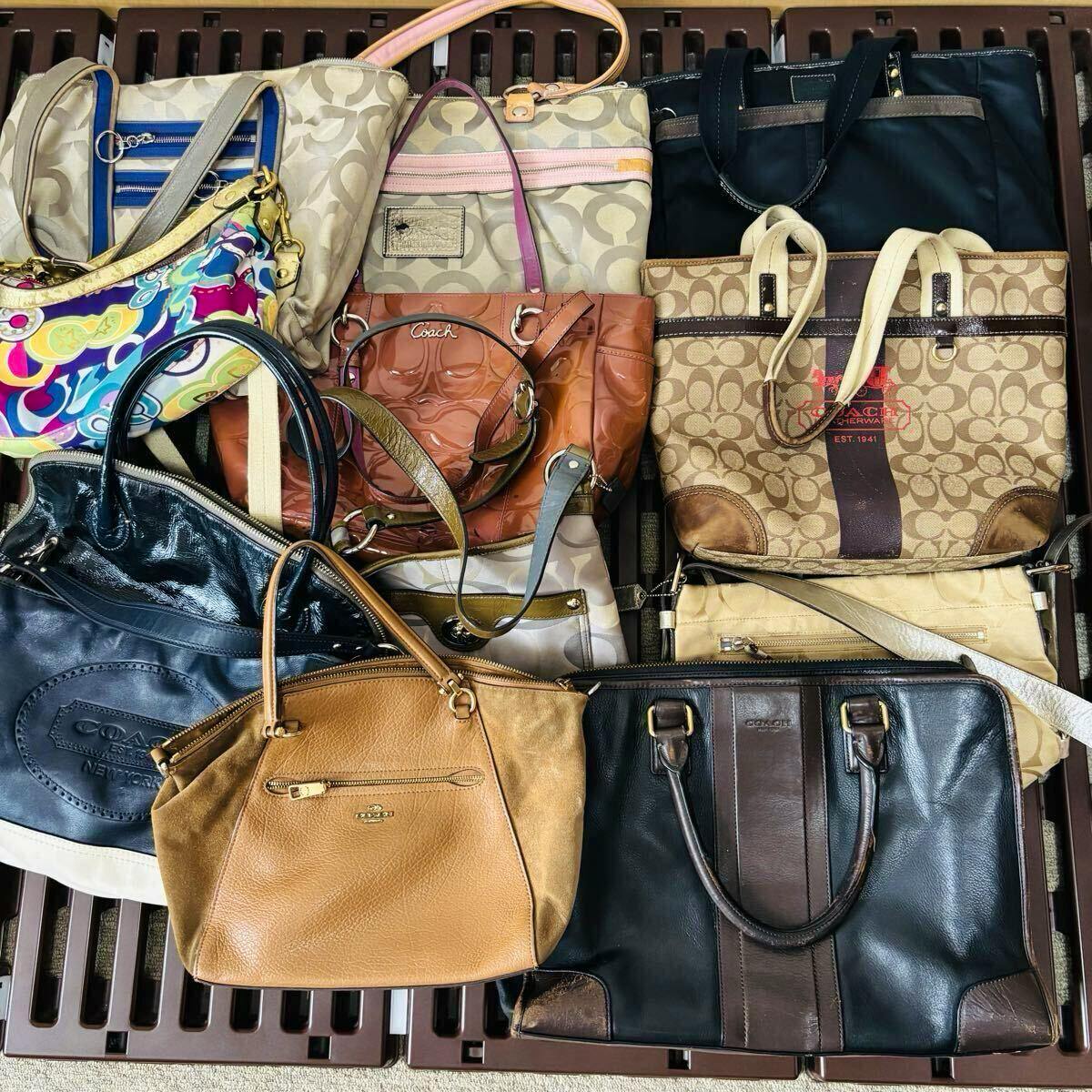 Assorted COACH bags and totes arranged together, showing various colors, patterns, and handles.