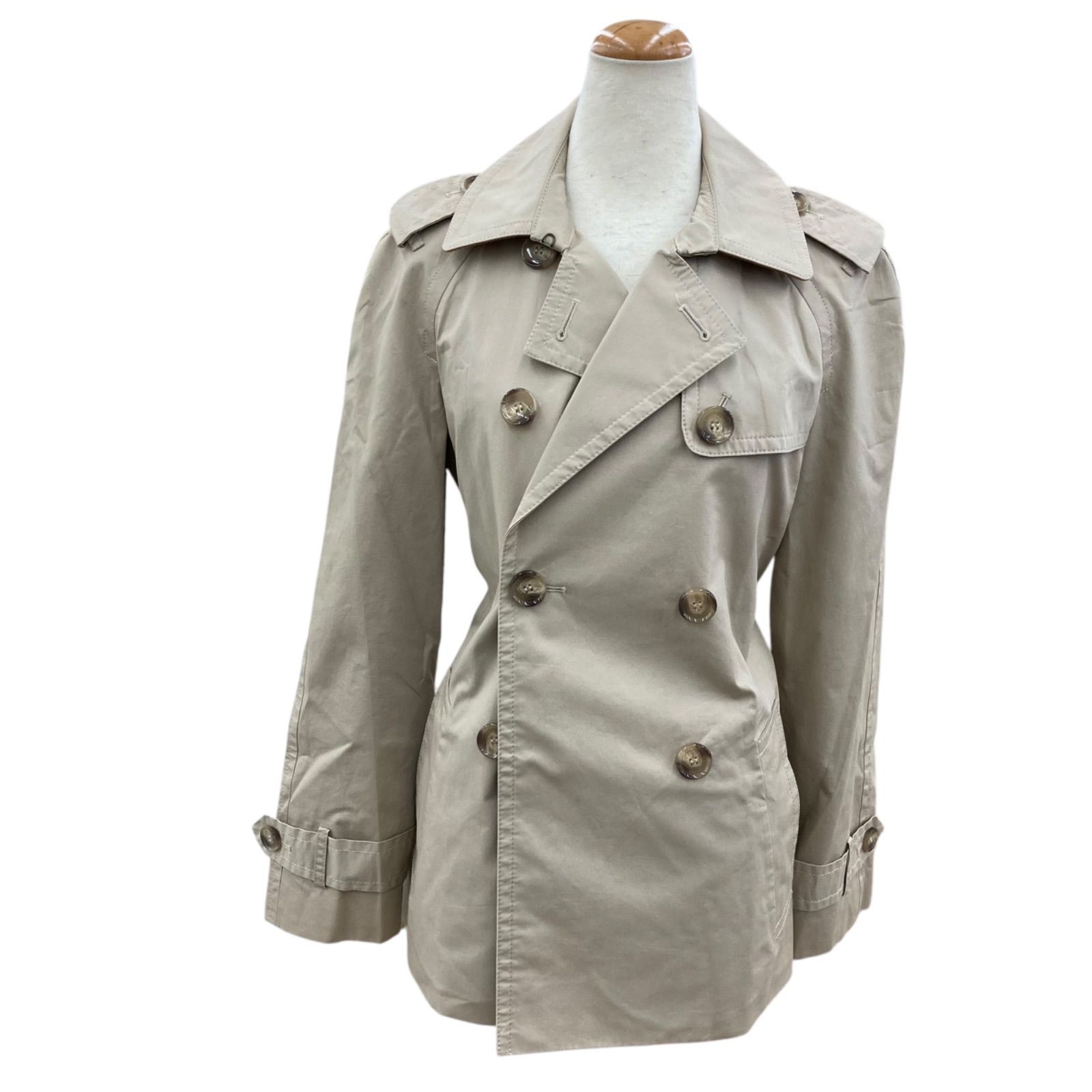Beige COACH trench coat (men's) double-breasted displayed on a mannequin.