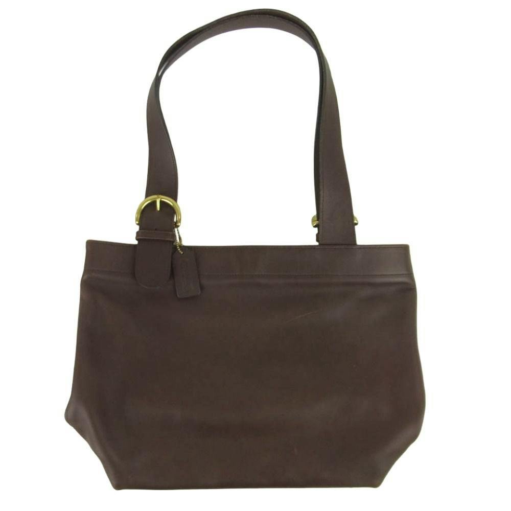 Front view of a dark brown COACH Old Coach Waverly leather tote bag with shoulder straps and buckle detail.