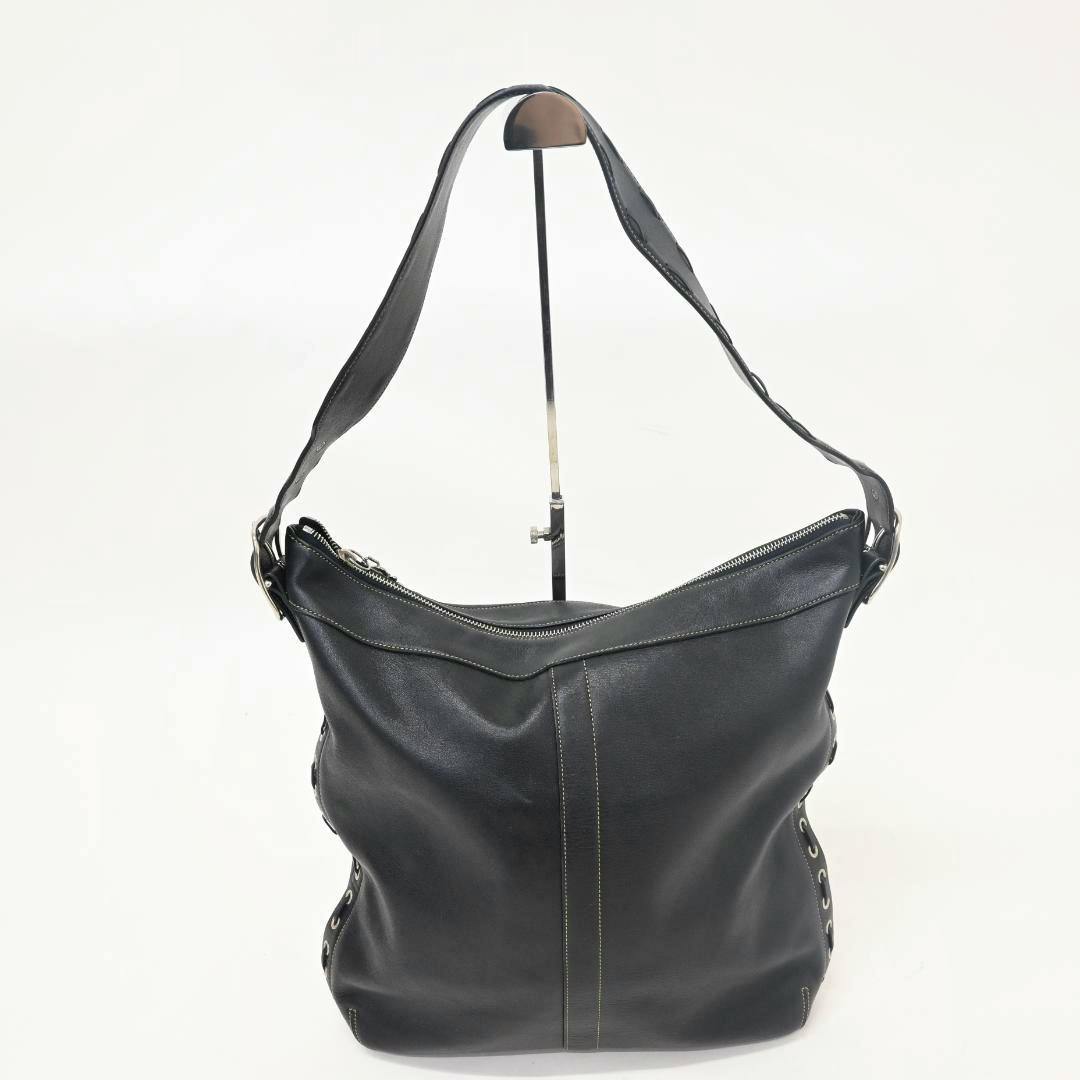 Black COACH one-handle leather shoulder bag photographed on a stand against a white background.