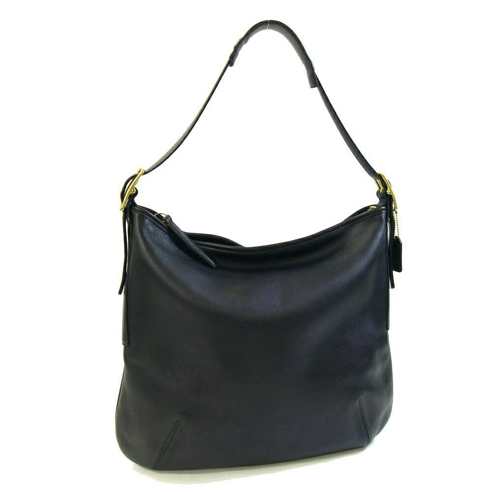 Front view of a black Coach one-shoulder leather bag with a single shoulder strap and gold hardware.