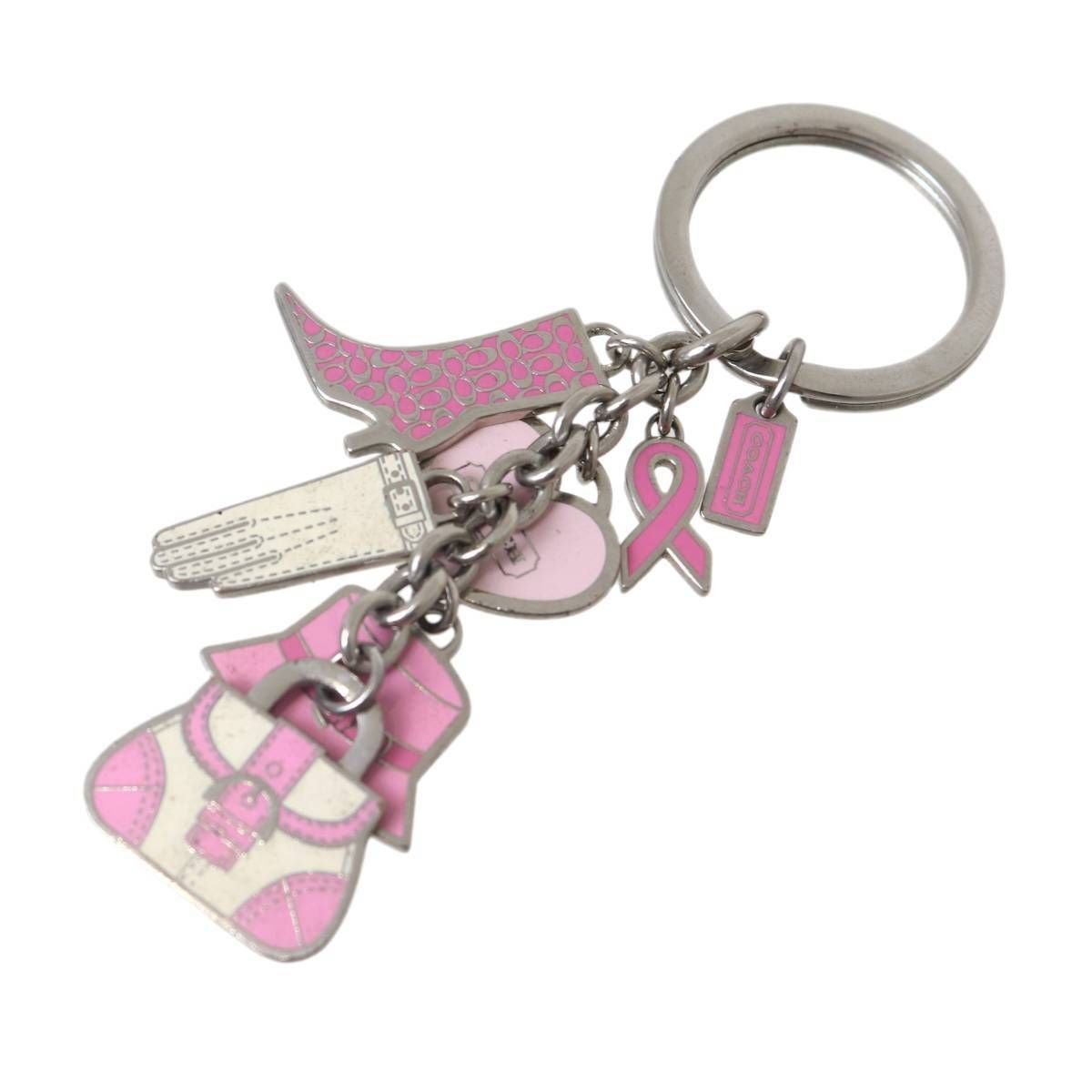 Silver key ring with multiple pink Coach bag-charm pendants including a ribbon, small bag, glove, hat, and rectangular tag.