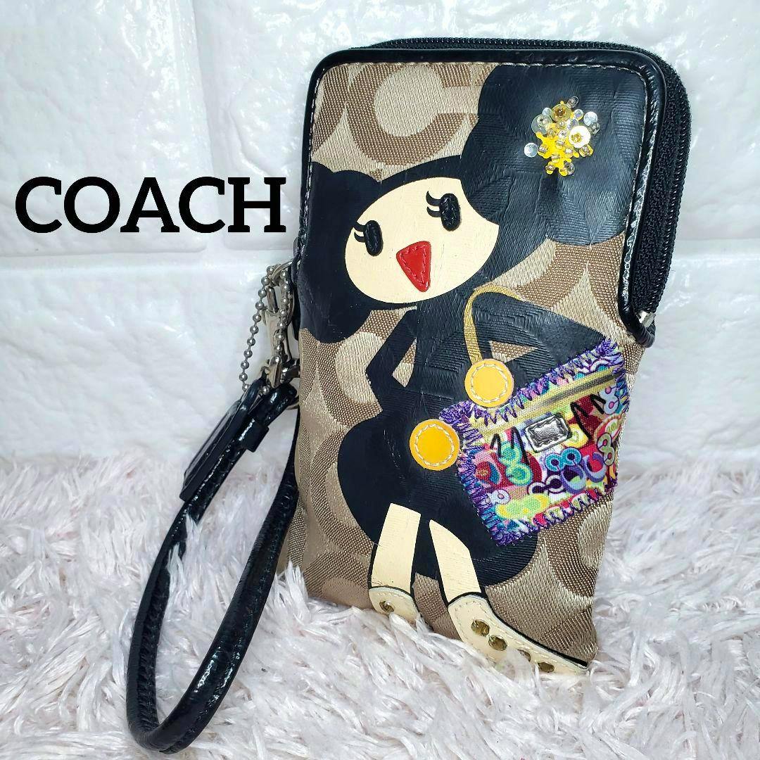 Front view of a COACH Poppy card/coin multi pouch featuring the Poppy character and a wrist strap.