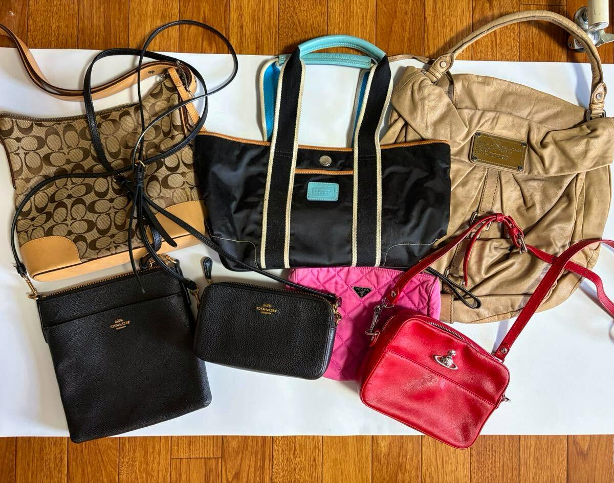 Seven assorted bags, including a COACH bag, arranged on a white background.