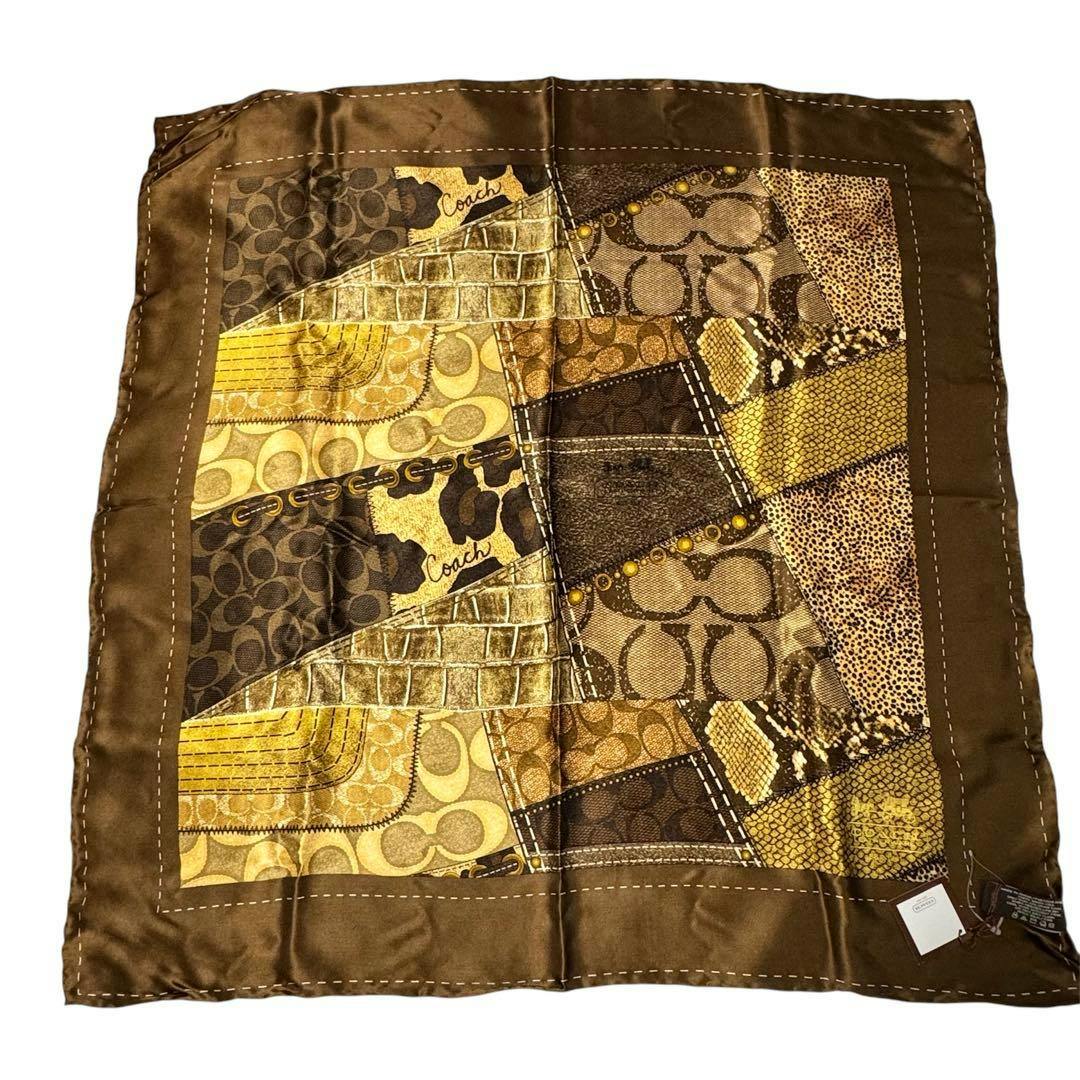 Square brown and gold Coach polyester scarf with a patchwork-style pattern laid flat.