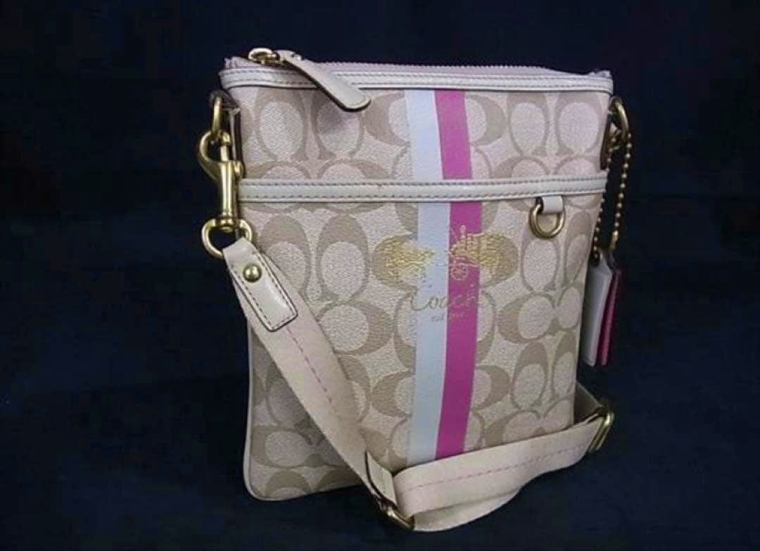 Front view of a beige and pink Coach canvas shoulder bag with signature 'C' pattern and a vertical pink and white stripe.