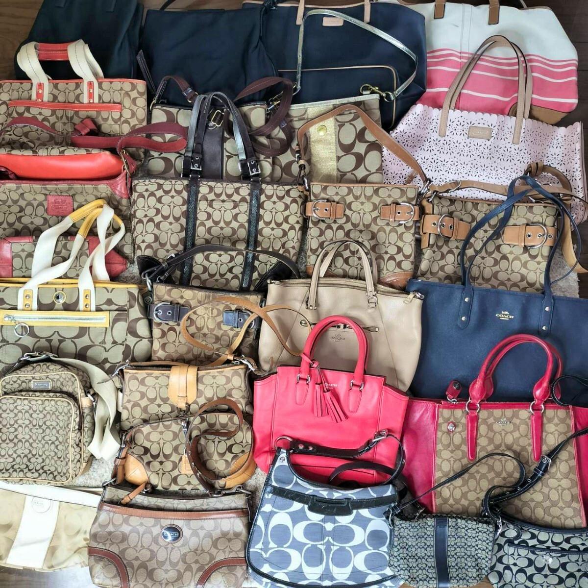 Multiple Coach signature canvas and leather bags in various colors arranged together as a bulk set.